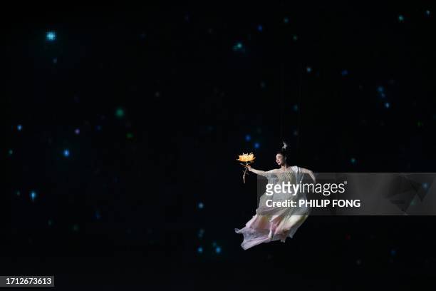 Performer participates in the closing ceremony of the 2022 Asian Games at the Hangzhou Olympic Sports Centre Stadium in Hangzhou in China's eastern...