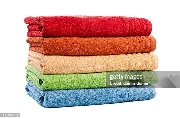 five stacked multicoloured bath towels isolated on white background, studio - towel stock pictures, royalty-free photos & images