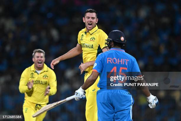 Australia's Josh Hazlewood celebrates after taking the wicket of India's captain Rohit Sharma during the 2023 ICC Men's Cricket World Cup one-day...