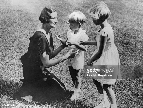Queen Astrid of Belgium with her two children King Baudouin of Belgium and Princess Josephine Charlotte of Belgium , 1935.