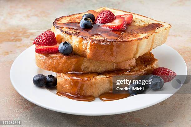 french toast with fruit and syrup on a marble countertop. - pain perdu stock pictures, royalty-free photos & images