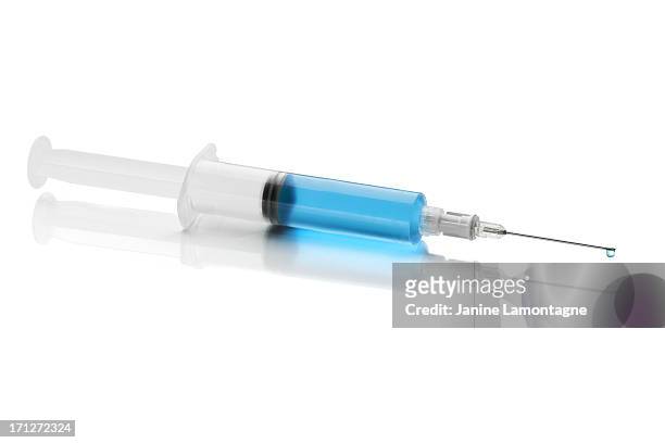 syringe with blue fluid on white background - surgical needle bildbanksfoton och bilder
