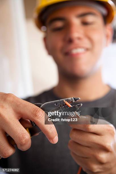 young electrician cutting insulation from wire - wire cutters stock pictures, royalty-free photos & images