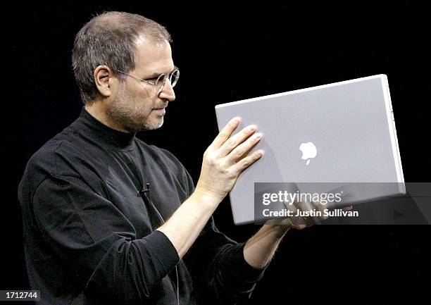 Apple CEO Steve Jobs shows off the new 17-inch Powerbook G4 while delivering the keynote address at Macworld January 7, 2003 in San Francisco. Along...