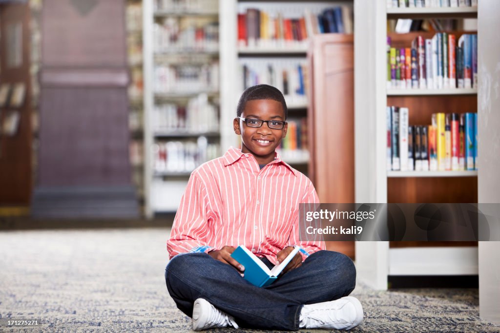Boy reading in library