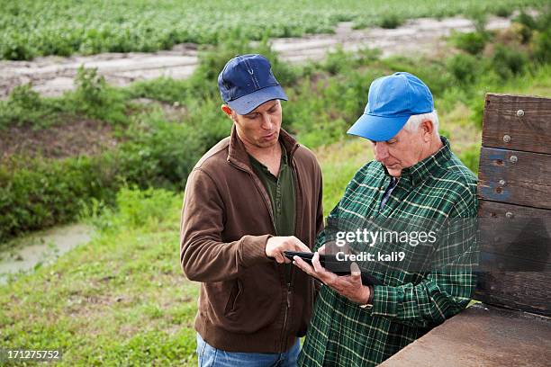 farmers using digital tablet on potato farm - father son business bildbanksfoton och bilder