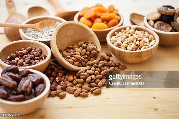 dry fruits and nuts at wooden table - dates fruit stock pictures, royalty-free photos & images