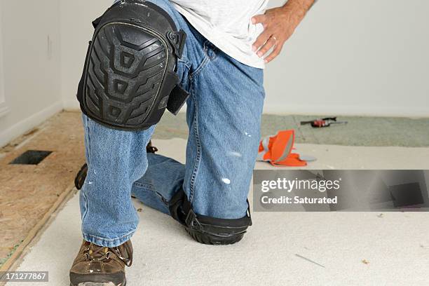 home improvement: kneeling worker's legs with kneepads - kneepad stock pictures, royalty-free photos & images