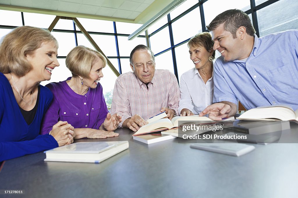 Library Reading Group Group Of Adults Reading In A Library Together High-Res Stock Photo ...