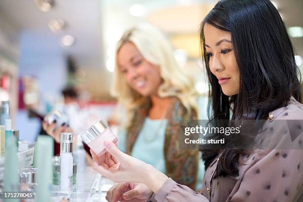 friends shopping for cream - cosmetics industry stock pictures, royalty-free photos & images