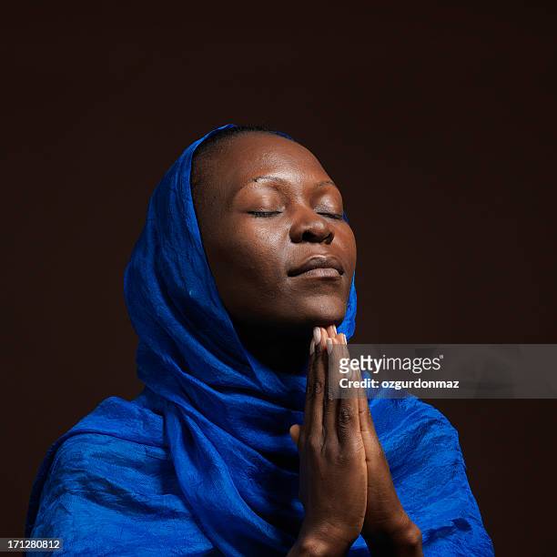 praying african woman - christianity black background stock pictures, royalty-free photos & images