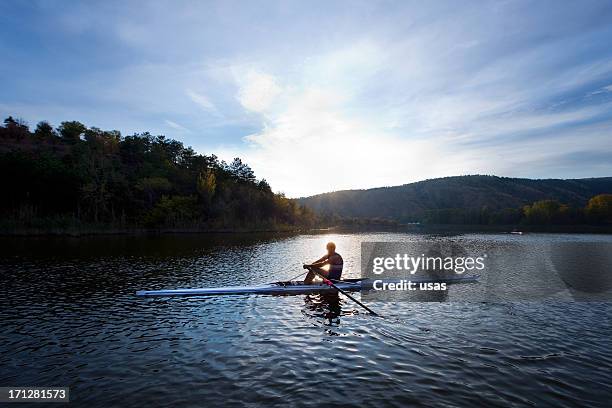 adult rower man rowing sculling boat on lake - single scull bildbanksfoton och bilder