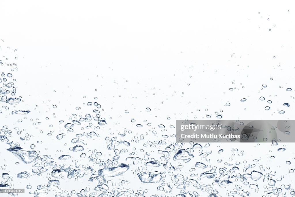 Blue air bubbles rising in clear fresh water