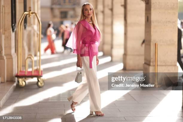 Anna Wohlthat is seen wearing pearl earrings, a silver pearl COS necklace, white Victorias Secret corsage and pink see through blouse over it from...