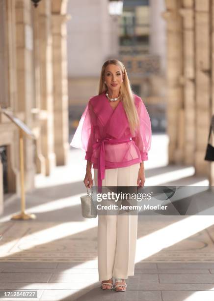 Anna Wohlthat is seen wearing pearl earrings, a silver pearl COS necklace, white Victorias Secret corsage and pink see through blouse over it from...