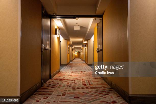 long corridor with warm yellow lighting - diamond pattern stock pictures, royalty-free photos & images