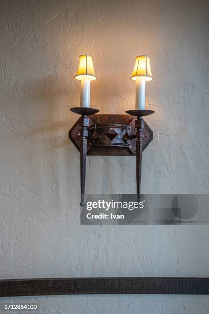 a sconce with illuminated electric candles - - modern judaism stock pictures, royalty-free photos & images