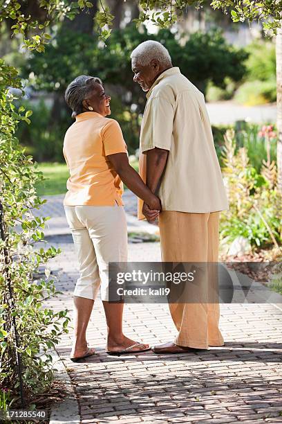 senior african american couple holding hands - man and woman holding hands profile stockfoto's en -beelden