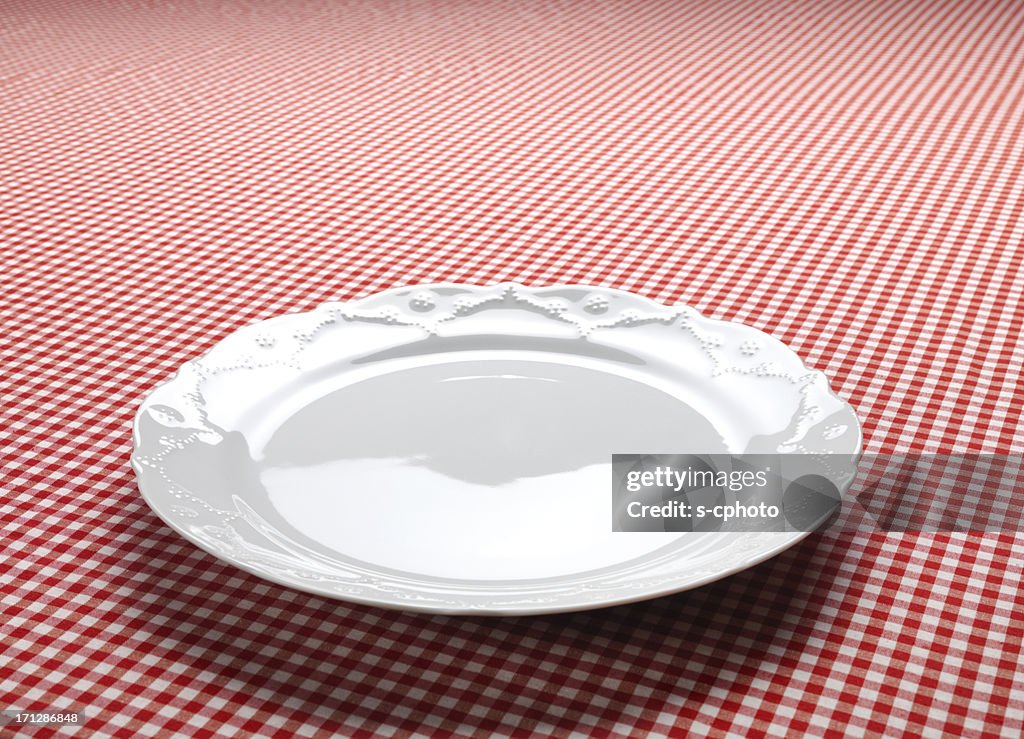 Empty Dish On The Checkered Tablecloth