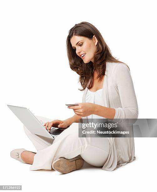 young girl with laptop and credit card - isolated - woman sitting cross legged stock pictures, royalty-free photos & images