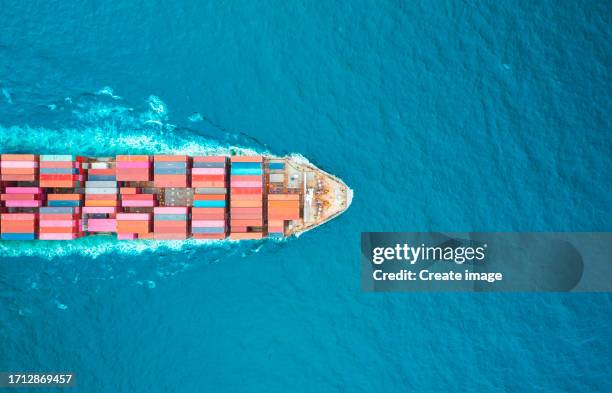 aerial top view container cargo ship full speed with beautiful wave pattern carrier container on the sea for business logistics, import export, shipping or freight transportation. - full elevator stock pictures, royalty-free photos & images