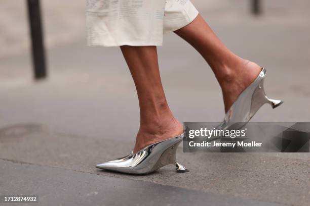 Guest is seen outside Hermes show wearing silver chunky heels during the Womenswear Spring/Summer 2024 as part of Paris Fashion Week on September 30,...