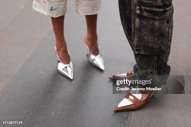 Guests are seen outside Hermes show wearing silver heels and brown and white MiuMiu sling back heels during the Womenswear Spring/Summer 2024 as part...