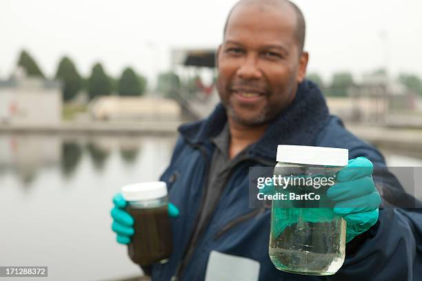 environmentalist at sewage treatment plant - sewage stock pictures, royalty-free photos & images