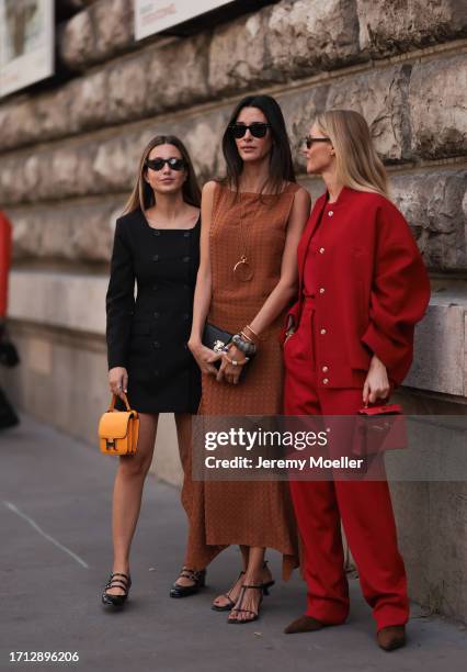 Paula Nata is seen outside Hermes show wearing black Rayban sunnies, brown long dress, black Hermes clutch, chunky gold and silver bracelets and...