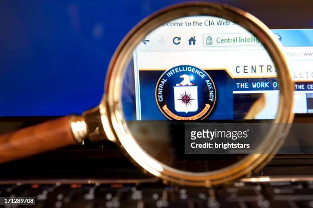 cia website through a magnifying glass - central intelligence agency stock pictures, royalty-free photos & images