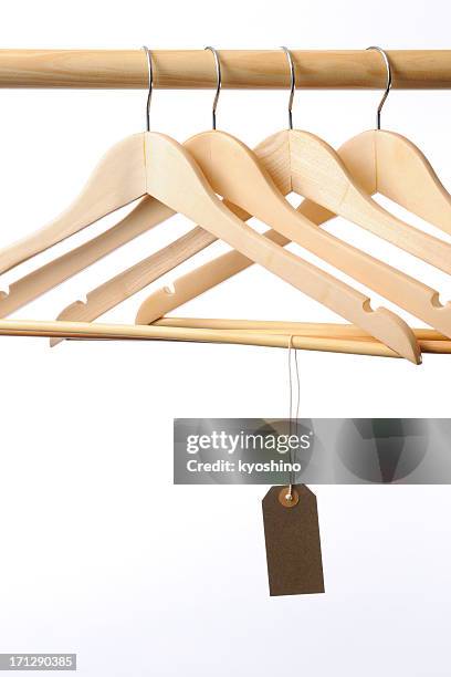 coat hanger with blank brown tag against white background - white coat fashion item stock pictures, royalty-free photos & images