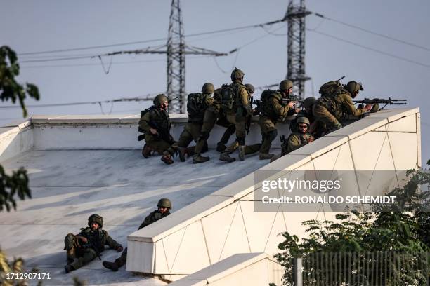 Israeli soldiers take a position near the southern city of Sderot on October 8, 2023. Surging violence between Israel and Hamas has killed almost...