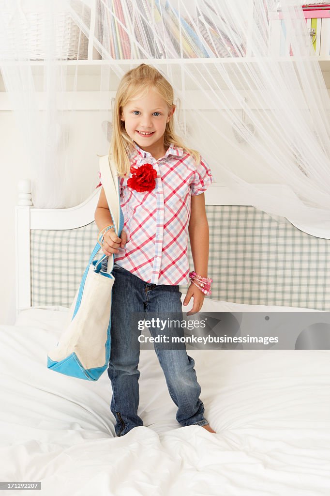Young Girl Dressing Up In Bedroom