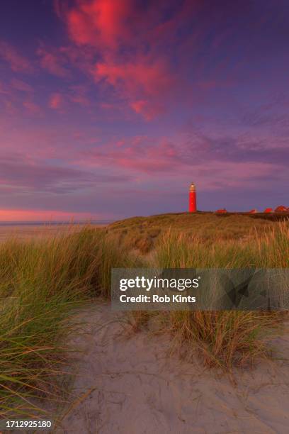 texel lighthouse near de cocksdorp and beautiful afterglow in the sky - red beacon stock pictures, royalty-free photos & images