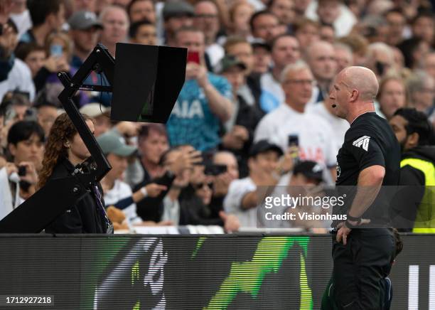 Referee Simon Hooper views the VAR monitor before sending off Curtis Jones of Livrpool during the Premier League match between Tottenham Hotspur and...