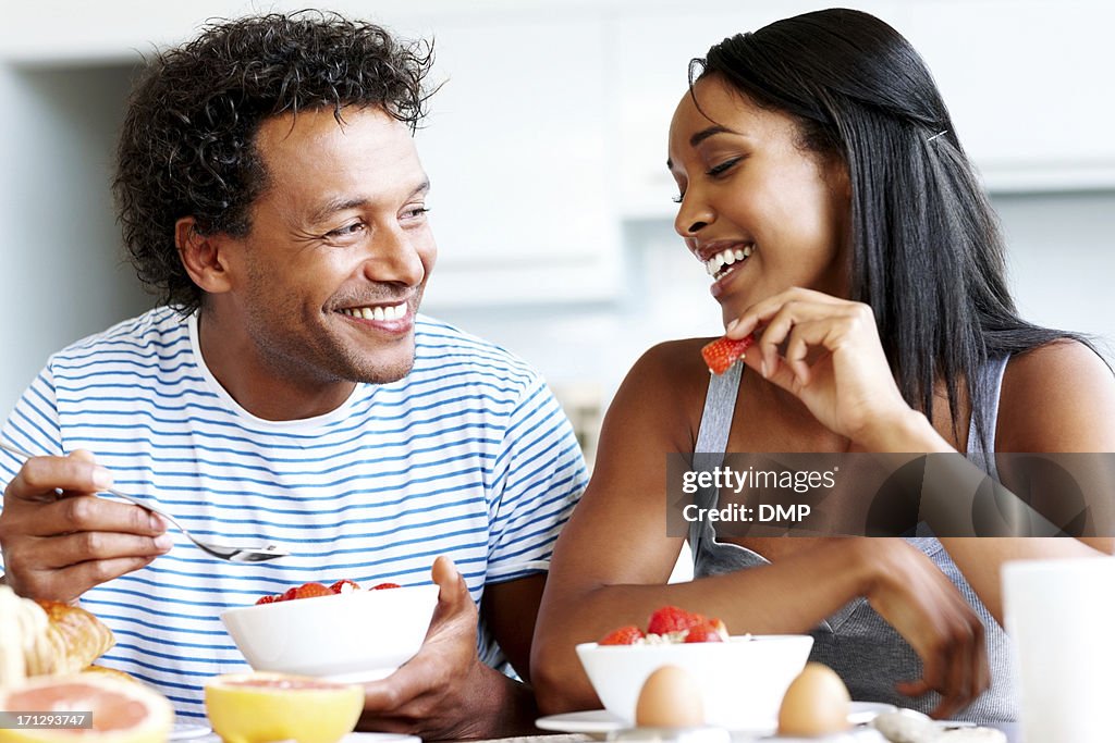 Happy couple having casual chat at breakfast table