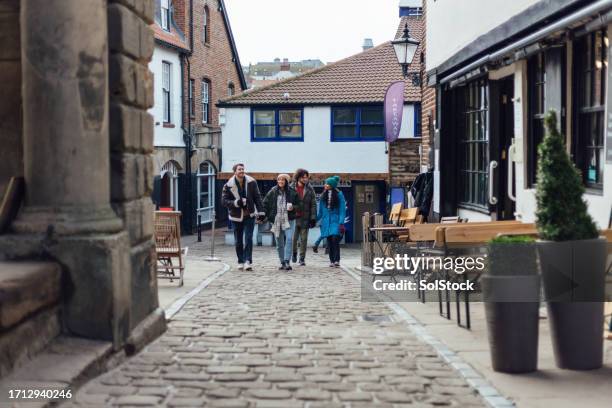 walking through whitby town - cobblestone stock pictures, royalty-free photos & images