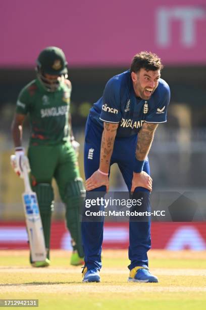 Reece Topley of England celebrates the wicket of Najmul Hossain Shanto of Bangladesh during the coss toss before the ICC Men's Cricket World Cup...