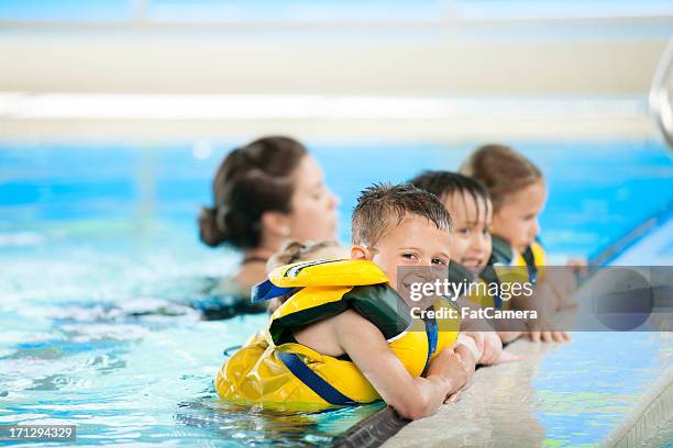 swimming lessons - toddler learning stock pictures, royalty-free photos & images