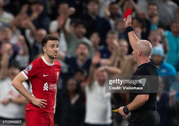 Diogo Jota of Liverpool is shown a red card by referee Simon Hooper during the Premier League match between Tottenham Hotspur and Liverpool FC at...