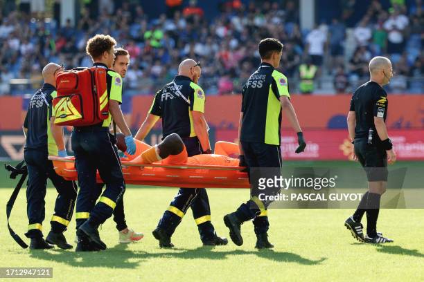 Clermont-Ferrand's French goalkeeper Mory Diaw injured by a firecracker, is evacuated on a stretcher during the French L1 football match between...