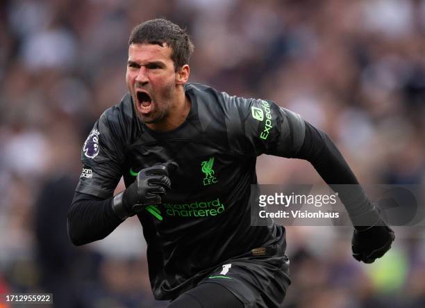 Alisson Becker of Liverpool celebrates as Liverpool score a goal that was later reversed during the Premier League match between Tottenham Hotspur...
