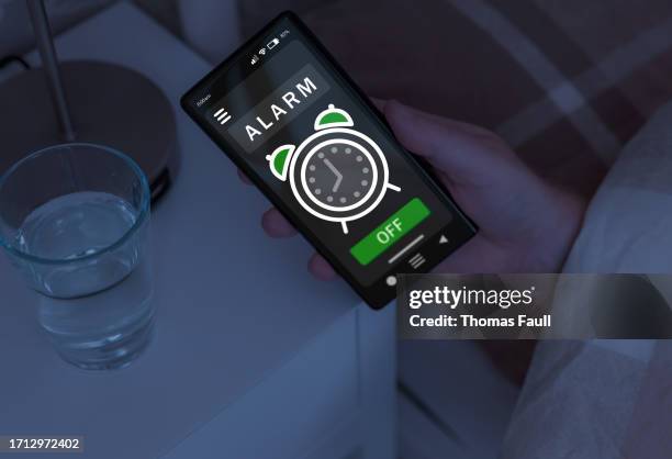 smartphone alarm - bedside table stock pictures, royalty-free photos & images