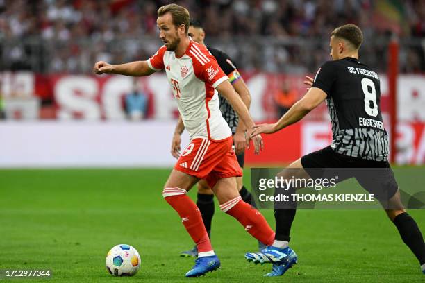 Bayern Munich's English forward Harry Kane and Freiburg's German midfielder Maximilian Eggestein vie for the ball during the German first division...