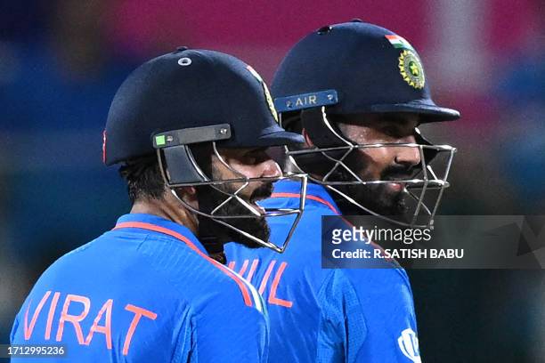 India's Virat Kohli and his teammate KL Rahul smile during the 2023 ICC Men's Cricket World Cup one-day international match between India and...