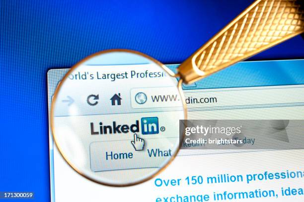 magnifying glass held over linkedin website - hyperlink stock pictures, royalty-free photos & images