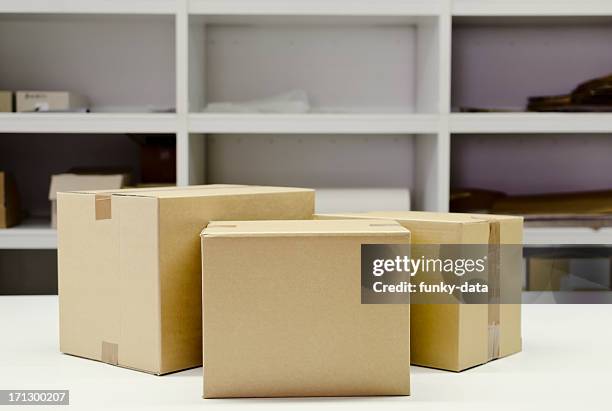 cardboard boxes on the table - three stacked boxes stock pictures, royalty-free photos & images