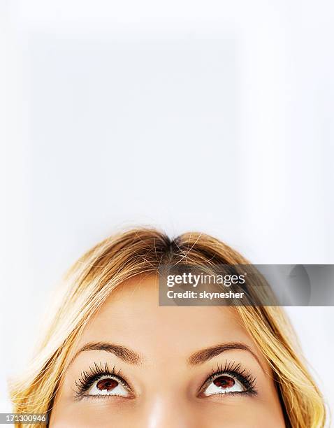 close-up of a young woman looking up - upper stock pictures, royalty-free photos & images