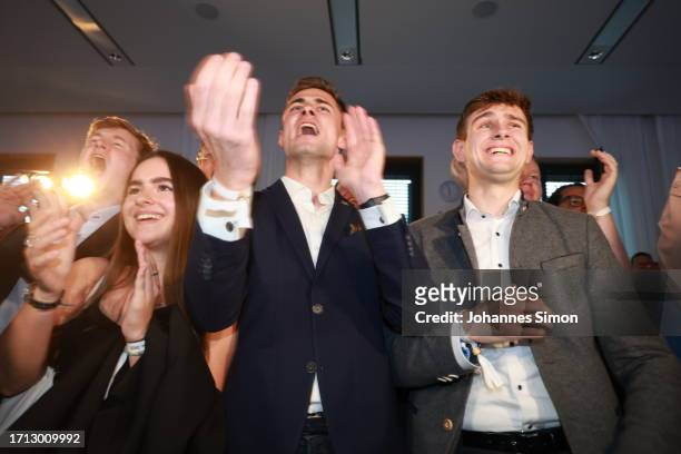Supporters of the Christian Social Union , the Bavarian sister party to the German Christian Democrats , react to initial results in Bavarian state...