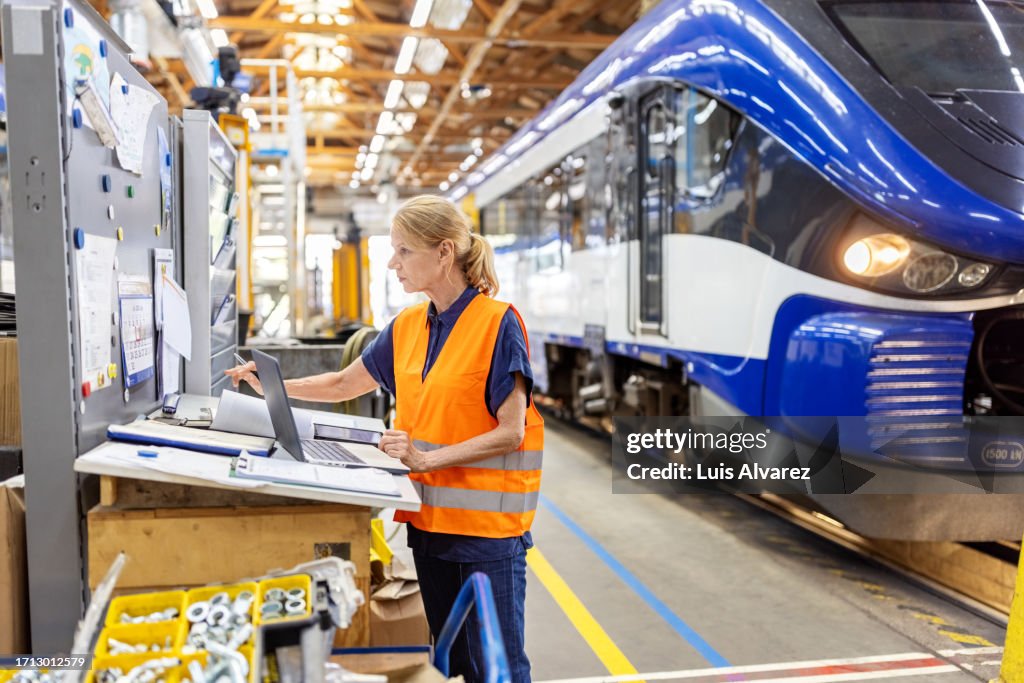 Trainno Engineer Mature Woman Engineer Working On The Desk At Train Workshop High-Res ...
